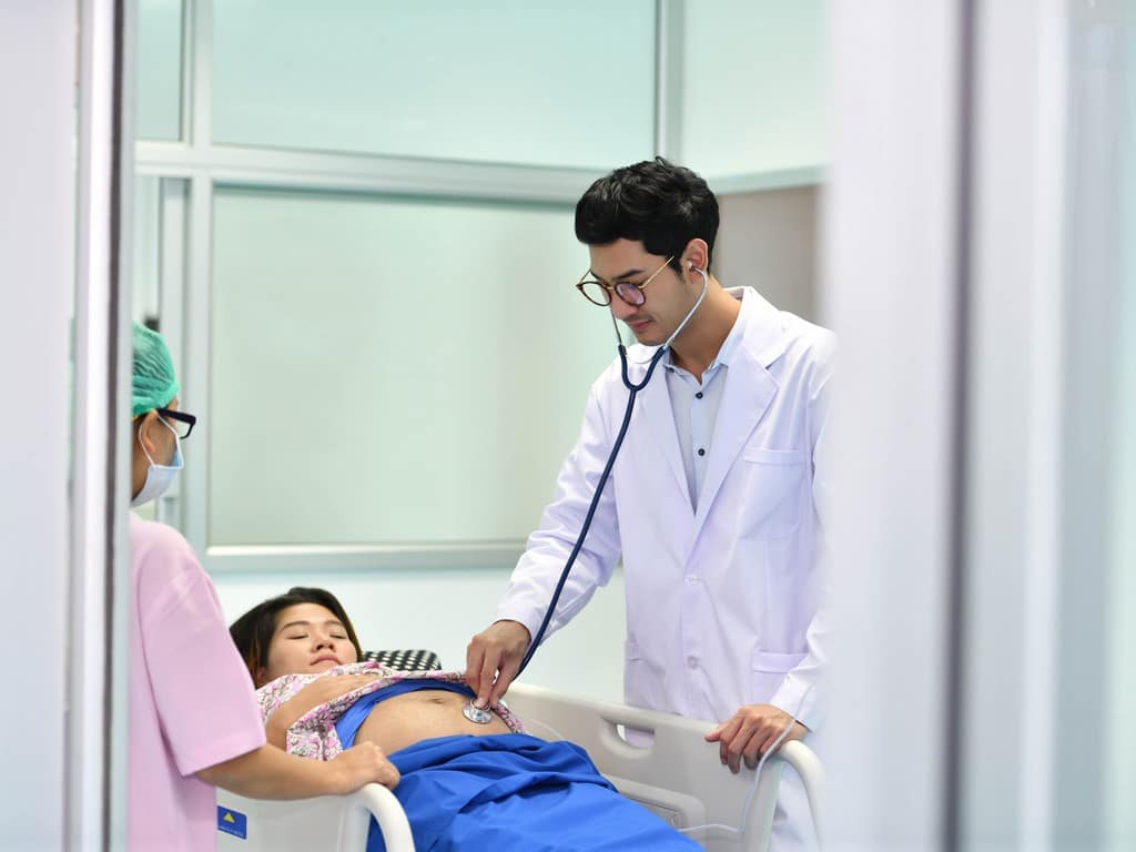 Buy condo in Pattaya doctor nurse examining pregnant woman 2023 11 27 05 02 20 utc
